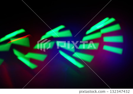 Neon Light Patterns. Abstract image of dynamic green light trails on a dark background. Neon Light Patterns. Abstract image of dynamic green light trails on a dark background. 132347432