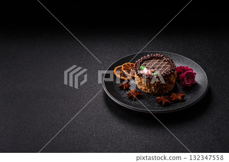 Sweet tart, pie with chocolate and cream with fruit filling on a plate. Chocolate tart Sweet tart, pie with chocolate and cream with fruit filling on a plate. Chocolate tart 132347558