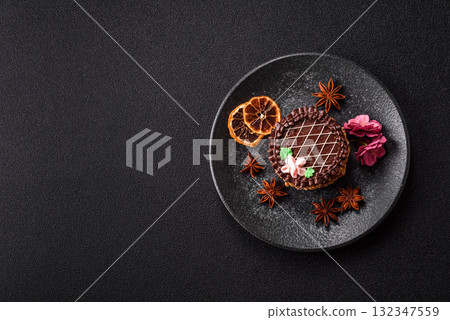 Sweet tart, pie with chocolate and cream with fruit filling on a plate. Chocolate tart 132347559