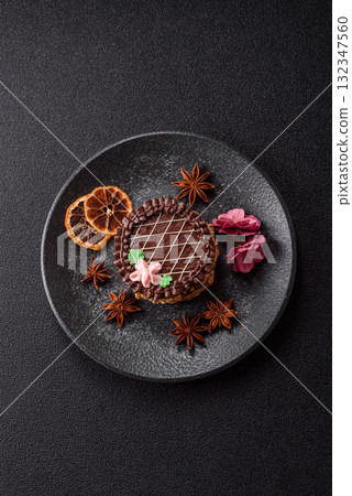 Sweet tart, pie with chocolate and cream with fruit filling on a plate. Chocolate tart 132347560