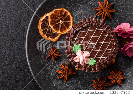 Sweet tart, pie with chocolate and cream with fruit filling on a plate. Chocolate tart Sweet tart, pie with chocolate and cream with fruit filling on a plate. Chocolate tart 132347563