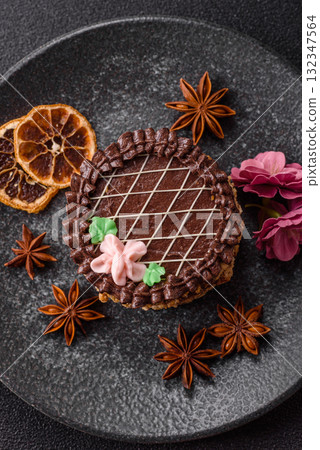 Sweet tart, pie with chocolate and cream with fruit filling on a plate. Chocolate tart Sweet tart, pie with chocolate and cream with fruit filling on a plate. Chocolate tart 132347564
