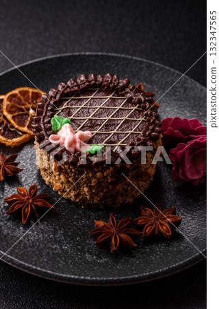 Sweet tart, pie with chocolate and cream with fruit filling on a plate. Chocolate tart Sweet tart, pie with chocolate and cream with fruit filling on a plate. Chocolate tart 132347565
