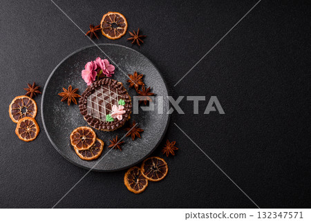 Sweet tart, pie with chocolate and cream with fruit filling on a plate. Chocolate tart Sweet tart, pie with chocolate and cream with fruit filling on a plate. Chocolate tart 132347571