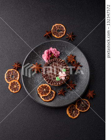 Sweet tart, pie with chocolate and cream with fruit filling on a plate. Chocolate tart 132347572