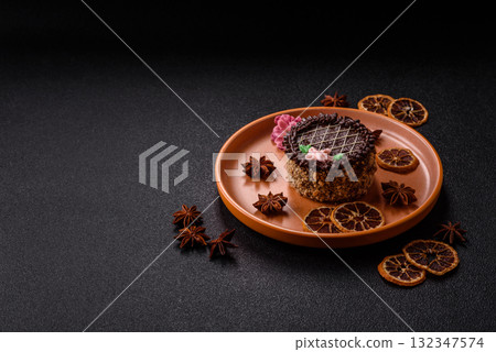 Sweet tart, pie with chocolate and cream with fruit filling on a plate. Chocolate tart 132347574