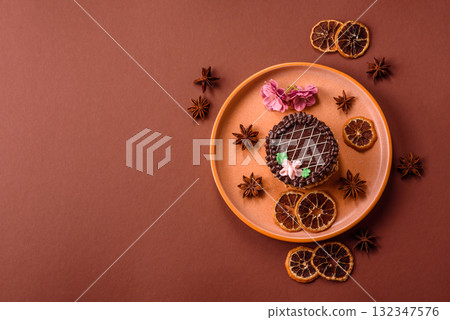 Sweet tart, pie with chocolate and cream with fruit filling on a plate. Chocolate tart 132347576