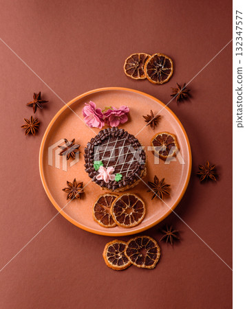 Sweet tart, pie with chocolate and cream with fruit filling on a plate. Chocolate tart Sweet tart, pie with chocolate and cream with fruit filling on a plate. Chocolate tart 132347577