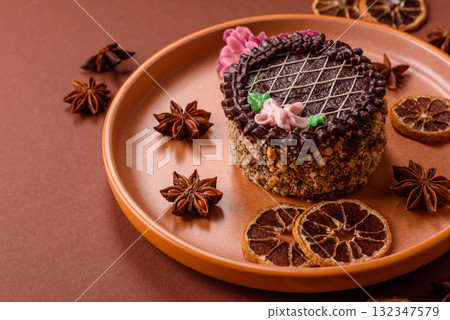 Sweet tart, pie with chocolate and cream with fruit filling on a plate. Chocolate tart 132347579