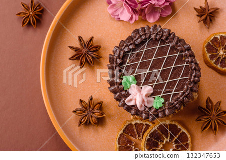 Sweet tart, pie with chocolate and cream with fruit filling on a plate. Chocolate tart 132347653
