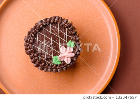Sweet tart, pie with chocolate and cream with fruit filling on a plate. Chocolate tart Sweet tart, pie with chocolate and cream with fruit filling on a plate. Chocolate tart 132347657