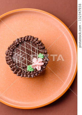 Sweet tart, pie with chocolate and cream with fruit filling on a plate. Chocolate tart Sweet tart, pie with chocolate and cream with fruit filling on a plate. Chocolate tart 132347658