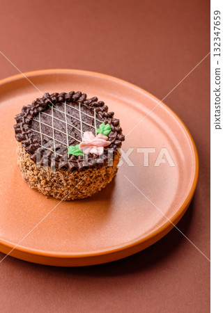 Sweet tart, pie with chocolate and cream with fruit filling on a plate. Chocolate tart 132347659