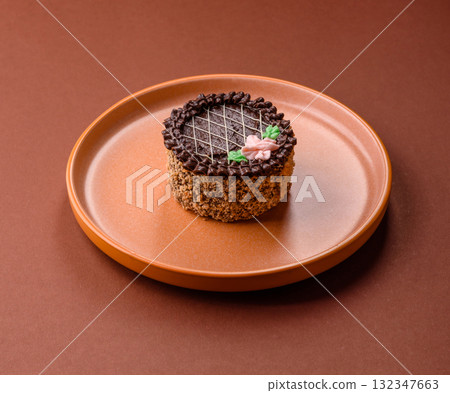 Sweet tart, pie with chocolate and cream with fruit filling on a plate. Chocolate tart 132347663