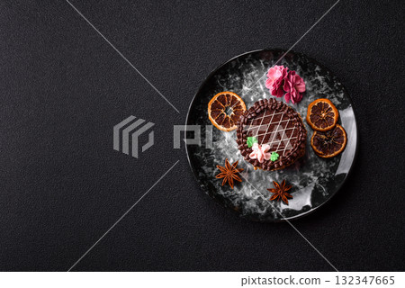 Sweet tart, pie with chocolate and cream with fruit filling on a plate. Chocolate tart 132347665