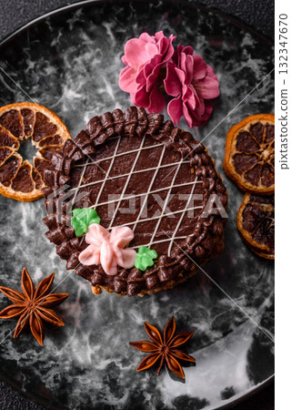 Sweet tart, pie with chocolate and cream with fruit filling on a plate. Chocolate tart Sweet tart, pie with chocolate and cream with fruit filling on a plate. Chocolate tart 132347670