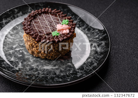 Sweet tart, pie with chocolate and cream with fruit filling on a plate. Chocolate tart Sweet tart, pie with chocolate and cream with fruit filling on a plate. Chocolate tart 132347672