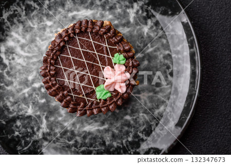 Sweet tart, pie with chocolate and cream with fruit filling on a plate. Chocolate tart Sweet tart, pie with chocolate and cream with fruit filling on a plate. Chocolate tart 132347673