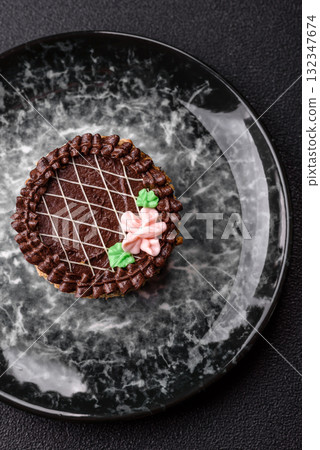 Sweet tart, pie with chocolate and cream with fruit filling on a plate. Chocolate tart Sweet tart, pie with chocolate and cream with fruit filling on a plate. Chocolate tart 132347674