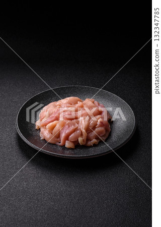 Raw chicken meat cut into strips, fresh fillet or breast slices. Chicken raw meat in pieces 132347785
