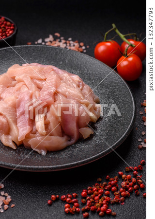 Raw chicken meat cut into strips, fresh fillet or breast slices. Chicken raw meat in pieces 132347793