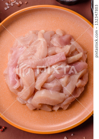 Raw chicken meat cut into strips, fresh fillet or breast slices. Chicken raw meat in pieces 132347803