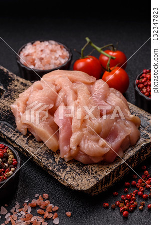 Raw chicken meat cut into strips, fresh fillet or breast slices. Chicken raw meat in pieces Raw chicken meat cut into strips, fresh fillet or breast slices. Chicken raw meat in pieces 132347823