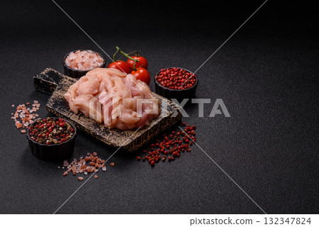Raw chicken meat cut into strips, fresh fillet or breast slices. Chicken raw meat in pieces Raw chicken meat cut into strips, fresh fillet or breast slices. Chicken raw meat in pieces 132347824