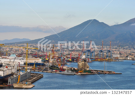 Naples, Italy - Seaport with cargo ships, cranes, and industrial buildings. 132347857