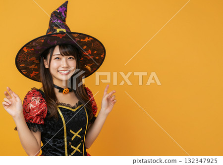 A woman dressed as a witch on an orange background 132347925