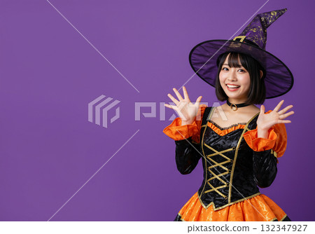 A woman dressed as a witch on a purple background 132347927