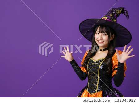 A woman dressed as a witch on a purple background 132347928