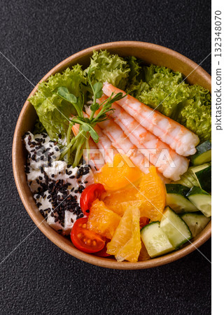 Bowl with shrimps, seafood, rice, oranges, tomatoes with sauce. Bowl with prawns Bowl with shrimps, seafood, rice, oranges, tomatoes with sauce. Bowl with prawns 132348070