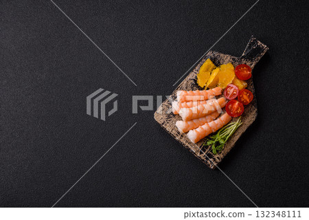 Bowl with shrimps, seafood, rice, oranges, tomatoes with sauce. Bowl with prawns 132348111