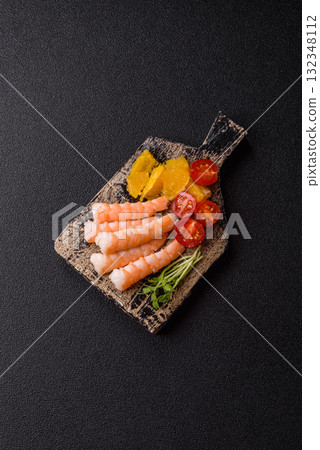 Bowl with shrimps, seafood, rice, oranges, tomatoes with sauce. Bowl with prawns Bowl with shrimps, seafood, rice, oranges, tomatoes with sauce. Bowl with prawns 132348112