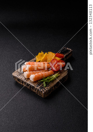 Bowl with shrimps, seafood, rice, oranges, tomatoes with sauce. Bowl with prawns Bowl with shrimps, seafood, rice, oranges, tomatoes with sauce. Bowl with prawns 132348113
