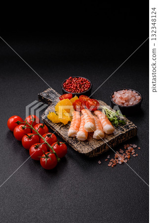 Bowl with shrimps, seafood, rice, oranges, tomatoes with sauce. Bowl with prawns 132348124