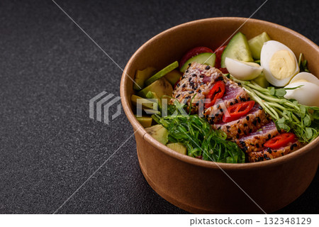 Seafood bowl, tuna tataki fillet slices with rice, oranges, tomatoes and sauce. Tuna bowl 132348129