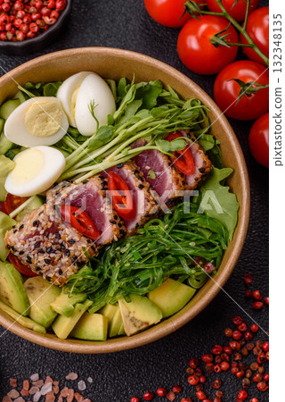 Seafood bowl, tuna tataki fillet slices with rice, oranges, tomatoes and sauce. Tuna bowl Seafood bowl, tuna tataki fillet slices with rice, oranges, tomatoes and sauce. Tuna bowl 132348135