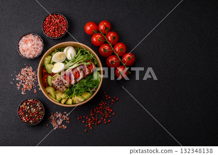 Seafood bowl, tuna tataki fillet slices with rice, oranges, tomatoes and sauce. Tuna bowl 132348138