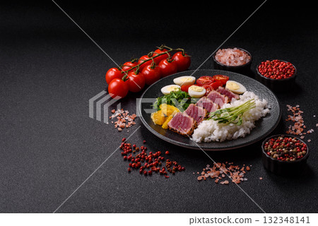 Seafood bowl, tuna tataki fillet slices with rice, oranges, tomatoes and sauce. Tuna bowl 132348141