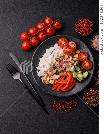 Bowl with chicken pieces, rice, tomatoes, peppers and microgreens. Bowl with chicken 132348365