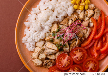 Bowl with chicken pieces, rice, tomatoes, peppers and microgreens. Bowl with chicken Bowl with chicken pieces, rice, tomatoes, peppers and microgreens. Bowl with chicken 132348381