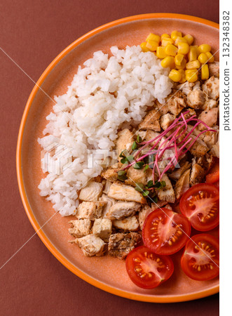 Bowl with chicken pieces, rice, tomatoes, peppers and microgreens. Bowl with chicken Bowl with chicken pieces, rice, tomatoes, peppers and microgreens. Bowl with chicken 132348382