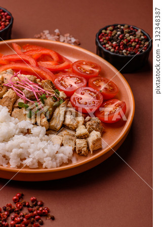 Bowl with chicken pieces, rice, tomatoes, peppers and microgreens. Bowl with chicken Bowl with chicken pieces, rice, tomatoes, peppers and microgreens. Bowl with chicken 132348387