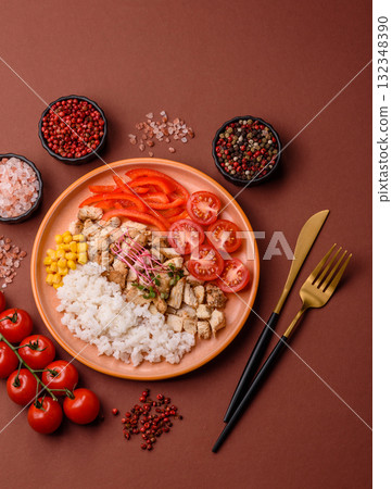 Bowl with chicken pieces, rice, tomatoes, peppers and microgreens. Bowl with chicken 132348390