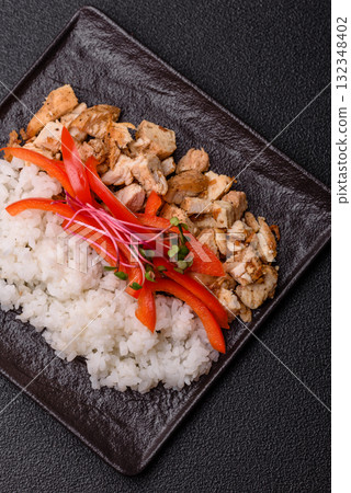 Bowl with chicken pieces, rice, tomatoes, peppers and microgreens. Bowl with chicken 132348402
