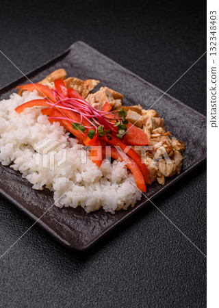 Bowl with chicken pieces, rice, tomatoes, peppers and microgreens. Bowl with chicken 132348403