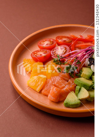 Bowl with salmon pieces, cheese, tomatoes, peppers and avocado. Salmon bowl 132348430