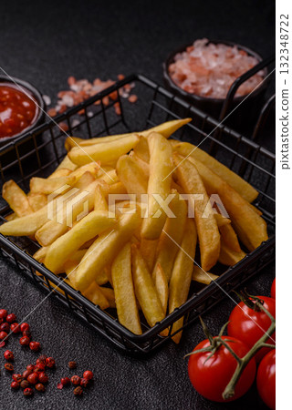 French fries, chips or snack with sauce as food background. French fries 132348722